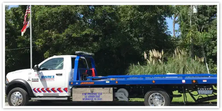 Wayne's Towing flatbed truck serving Econo Transmission customers